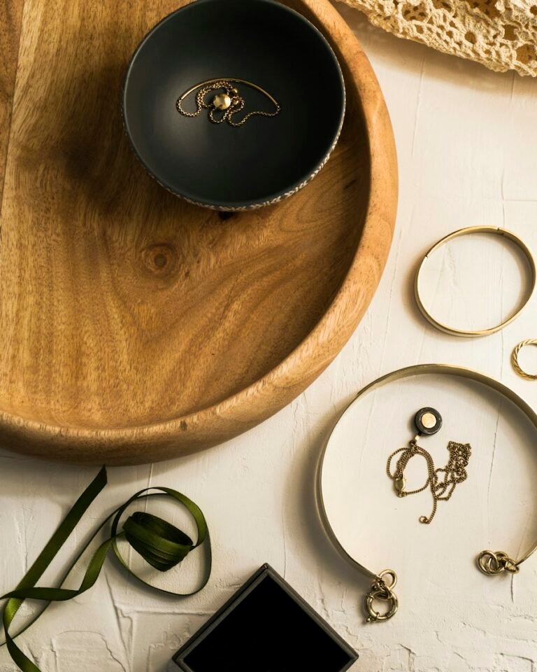 Gold jewellery on a wooden tray